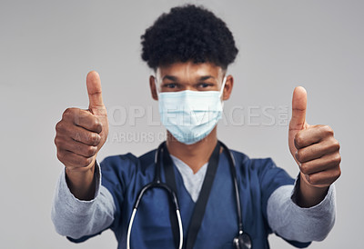 Buy stock photo Shot of a male nurse showing thumbs up while wearing a surgical mask