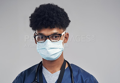 Buy stock photo Shot of a male nurse wearing a surgical mask while standing against a grey background