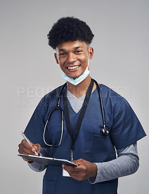 Buy stock photo Shot of a male nurse holding a clipboard while standing against a grey background