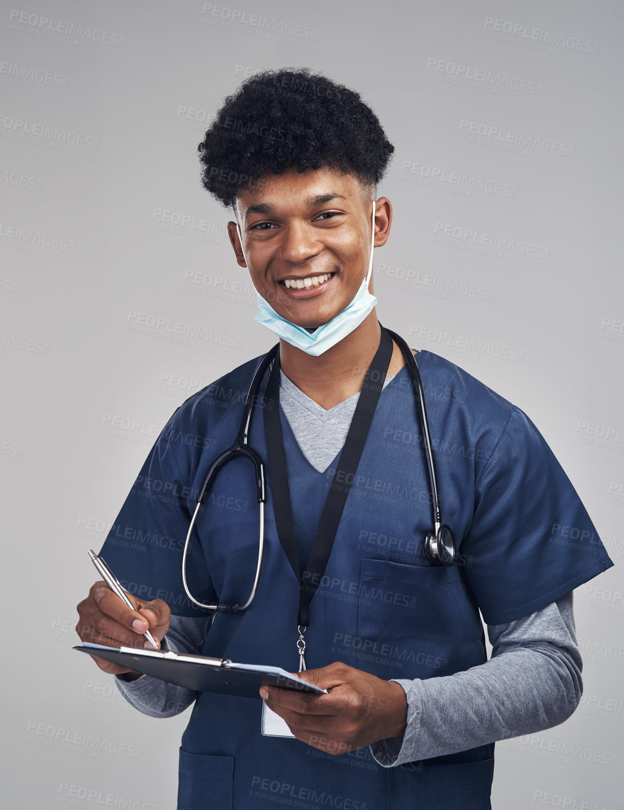 Buy stock photo Shot of a male nurse holding a clipboard while standing against a grey background