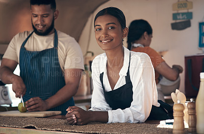 Buy stock photo Shot of a young businesswoman in her truck while her staff prepare food