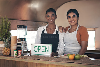 Buy stock photo Shot of a businesswoman holding an open sign for her food truck