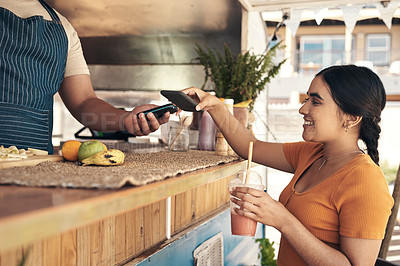 Buy stock photo Shot of a woman paying for her smoothie