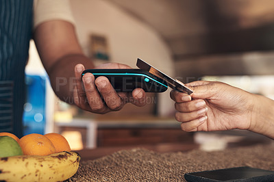 Buy stock photo Shot of a customer paying for their smoothie