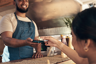 Buy stock photo Shot of a customer paying for their smoothie