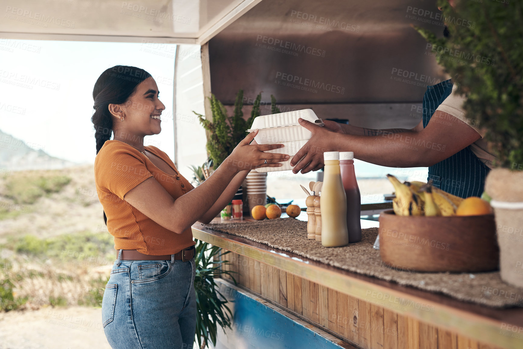 Buy stock photo Shot of a customer receiving their food order