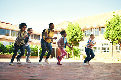 Buy stock photo Full length shot of a diverse group of children running outside during recess at school