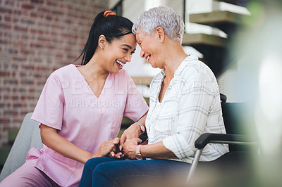 Buy stock photo Shot of a young nurse caring for an older woman in a wheelchair