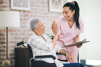 Buy stock photo Shot of a nurse and an older woman sharing a highfive in a moment of celebrated progress