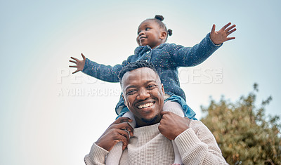 Buy stock photo Portrait of a father carrying his daughter on his shoulders outdoors