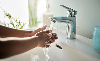 Buy stock photo Closeup shot of an unrecognisable boy washing his hands at a tap in a bathroom at home