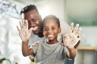 Buy stock photo Portrait of a boy holding up his soapy hands while standing in a bathroom with his father at home