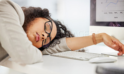 Buy stock photo Shot of a young businesswoman sleeping at her desk in an office