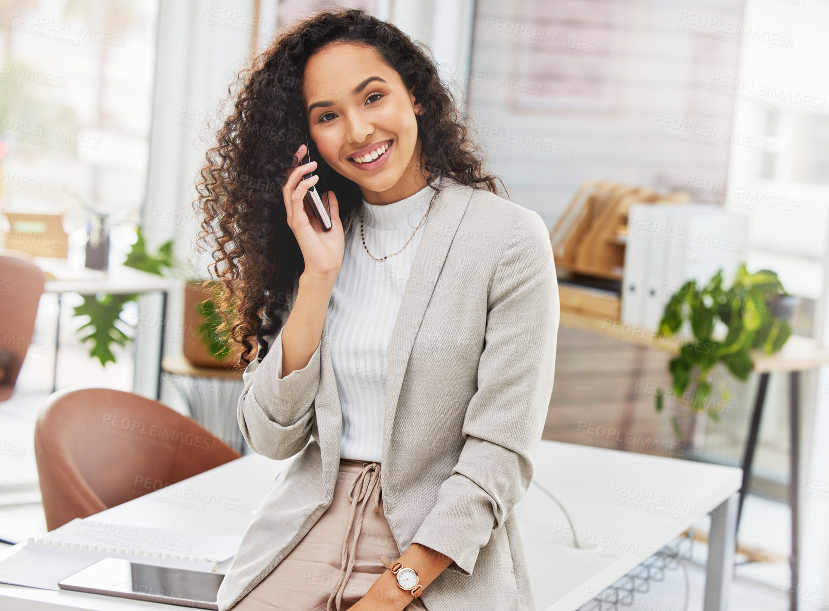 Buy stock photo Portrait of a young businesswoman talking on a cellphone in an office