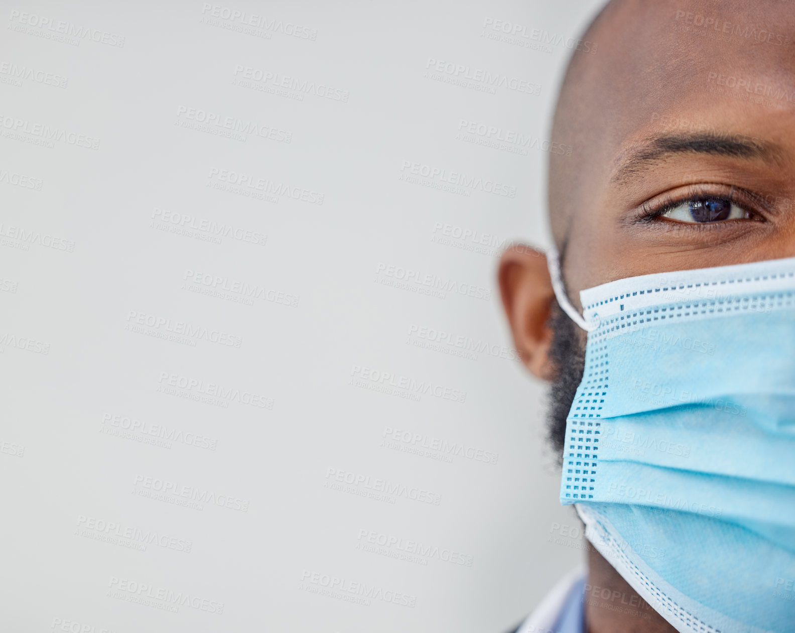 Buy stock photo Closeup shot of a young doctor wearing a mask at work