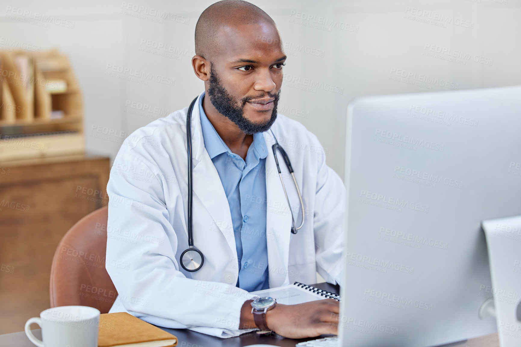 Buy stock photo Typing, reading and black man doctor with computer in hospital office for medical telehealth. Technology, online and healthcare worker with research for treatment or diagnosis on desktop in clinic.