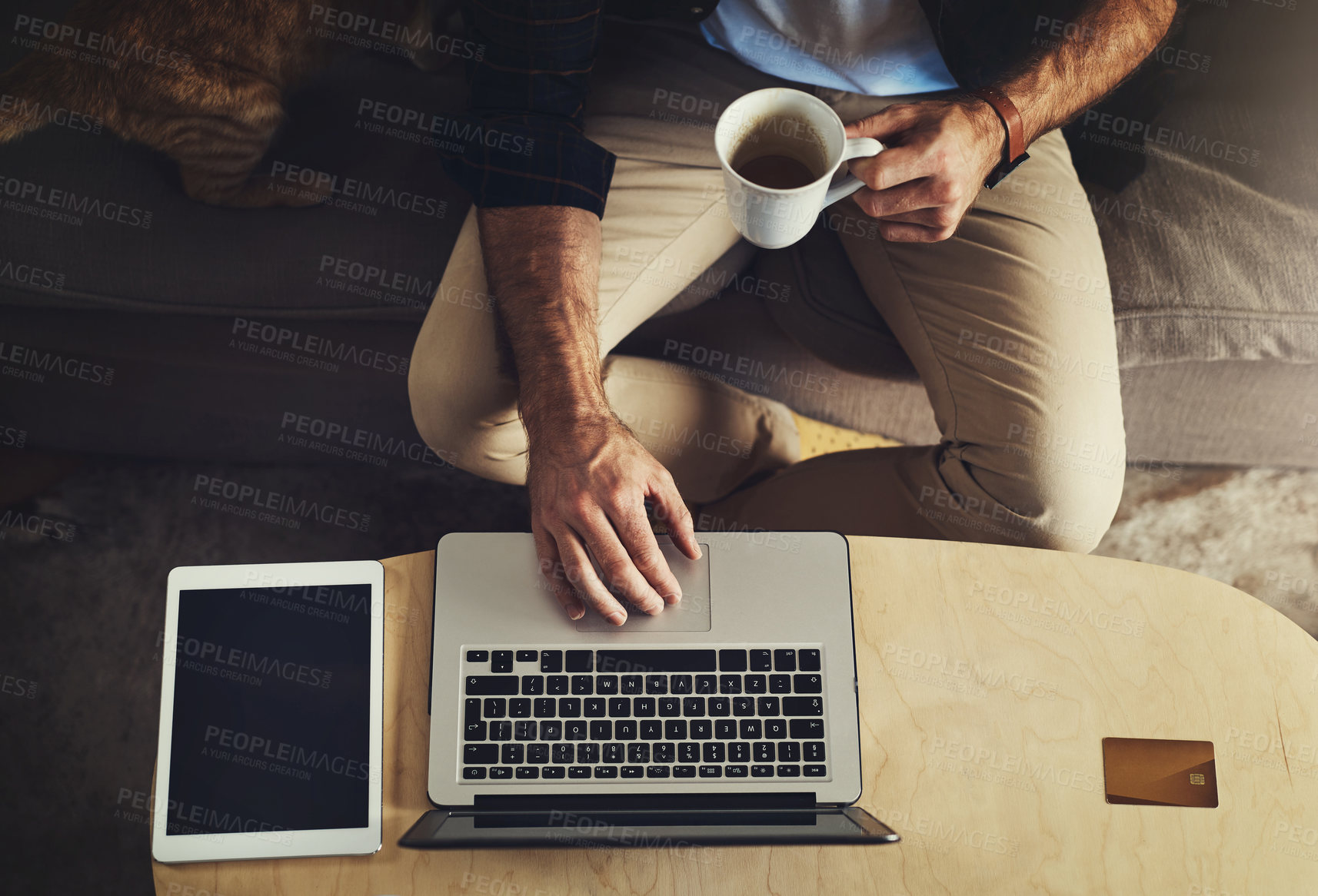 Buy stock photo Above, hands of man and laptop in home for remote work, ecommerce and digital trade on internet. Tech, coffee and person on sofa for research, company review and online feedback for small business