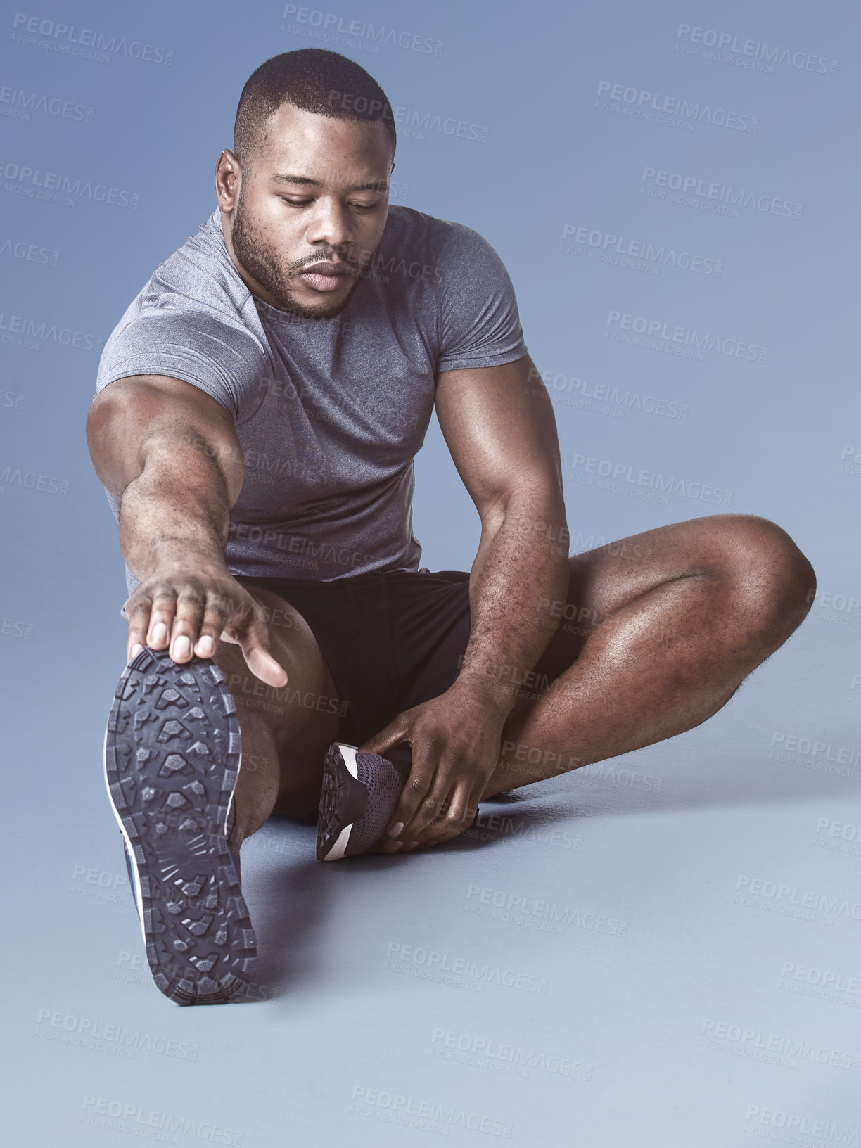 Buy stock photo Fitness, leg and stretching with sports black man on floor of studio background for health or wellness. Exercise, strong an warm up with confident athlete getting ready for training or workout