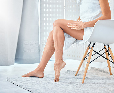 Buy stock photo Shot of a woman touching her legs in her bathroom