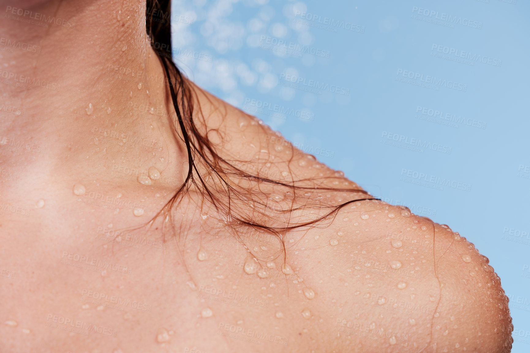 Buy stock photo Woman, cleanse and shower for shoulder in studio, washing and grooming for skincare on blue background. Female person, water and liquid for cosmetics or treatment and hydration, beauty and skin