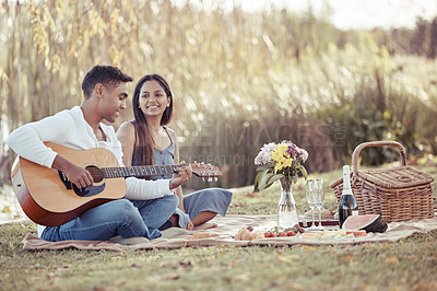 Buy stock photo Man, woman and date with picnic, guitar and romance for love or relationship anniversary. Couple, nature and lake with music, happiness and summer passion with bouquet for valentines celebration