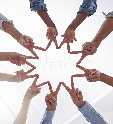 Buy stock photo Shot of a group of unrecognizable businesspeople making a star shape with their hands at work