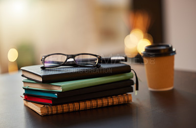 Buy stock photo Shot of a stack of books on a table in a office