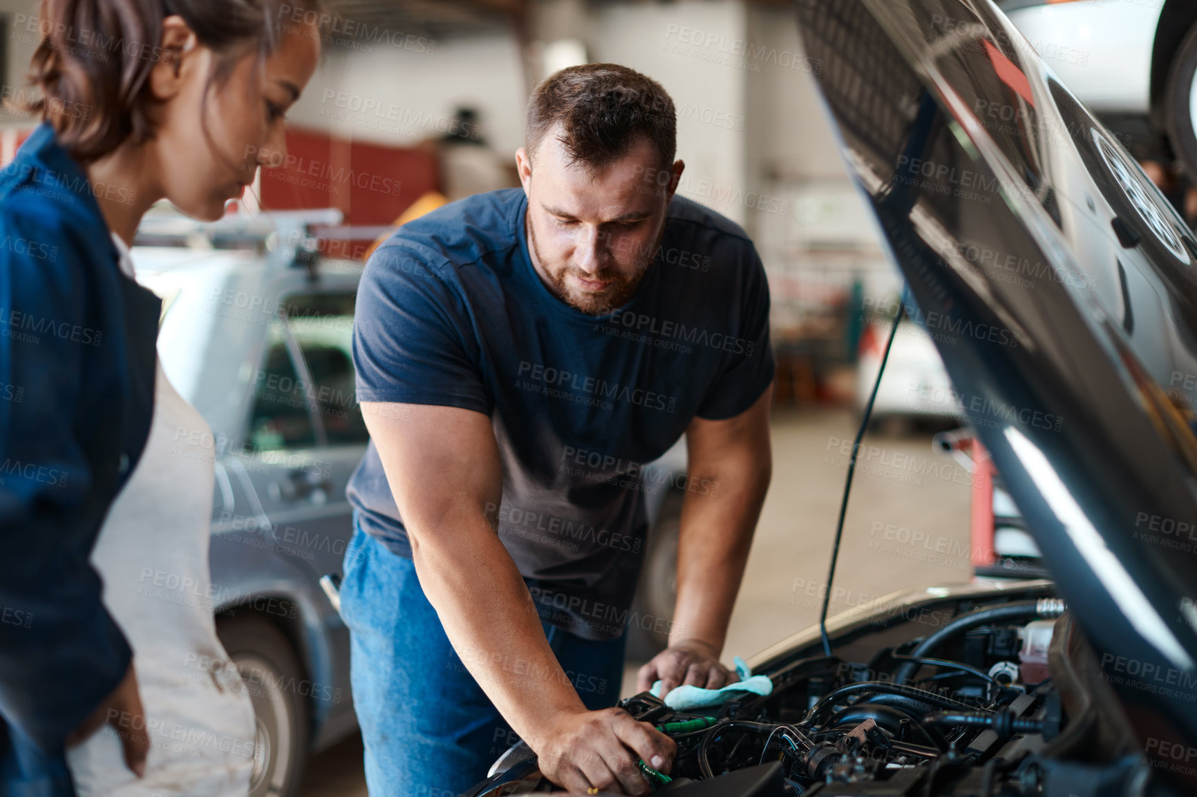 Buy stock photo People, mechanic and car engine with teamwork, maintenance or inspection for vehicle issue. Employees, entrepreneur or coworkers with industry, auto repair shop or cooperation with solution in garage