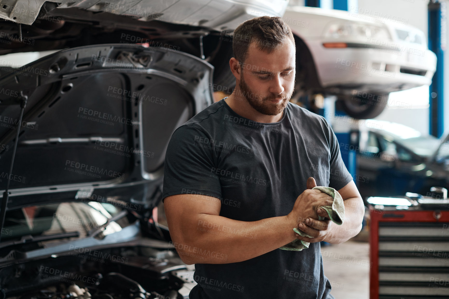 Buy stock photo Cleaning, hands and man in workshop with car service, maintenance or auto insurance at small business. Cloth, engine and mechanic in garage for oil change, motor repair or vehicle quality assurance