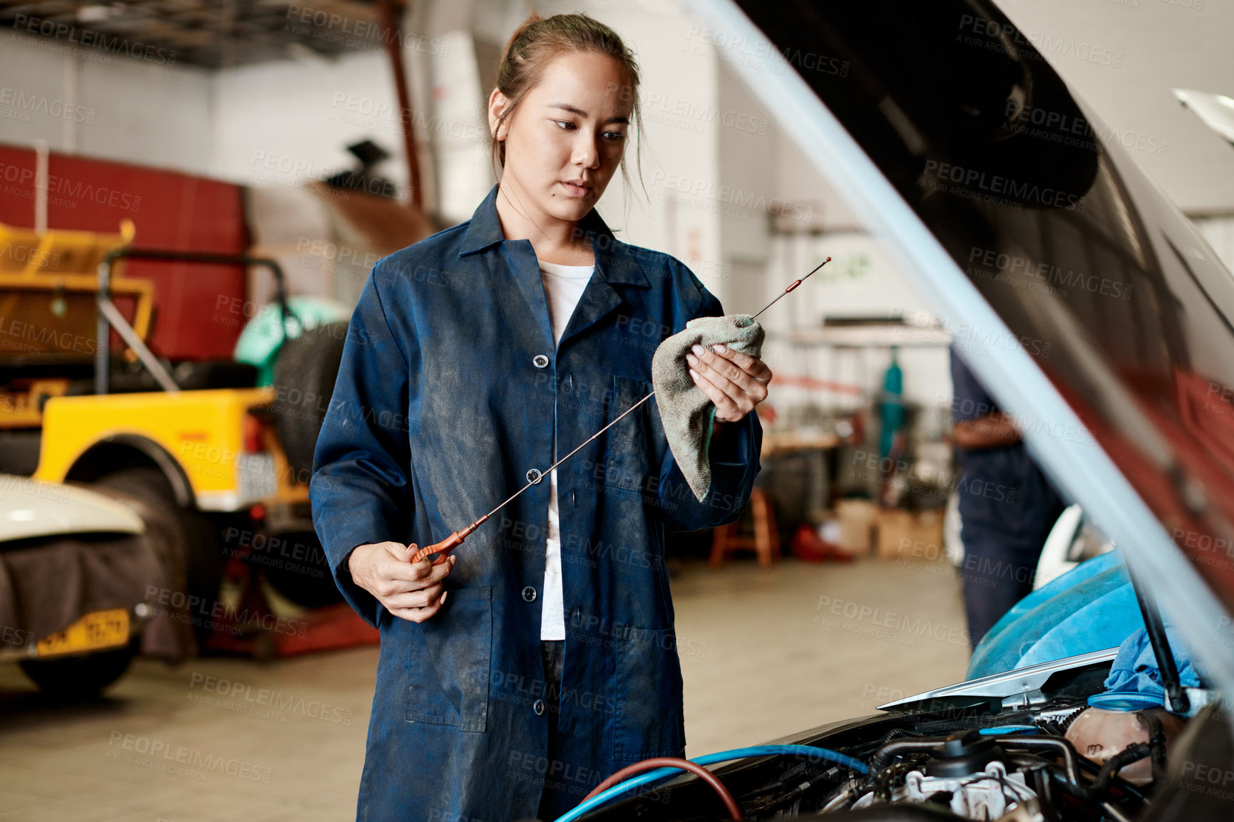 Buy stock photo Car, dipstick and mechanic with woman in workshop for maintenance, repair or service of engine. Auto, expert and inspection with asian vehicle engineer or technician checking oil level in garage