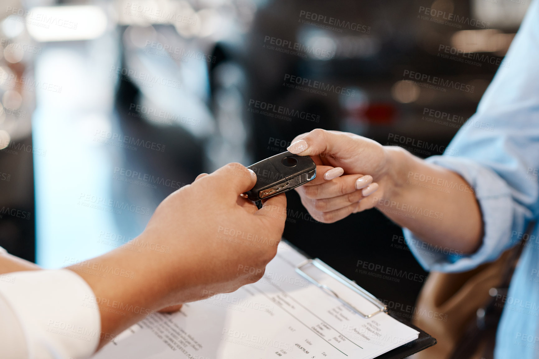 Buy stock photo Shot of a car salesman handing over keys to a customer