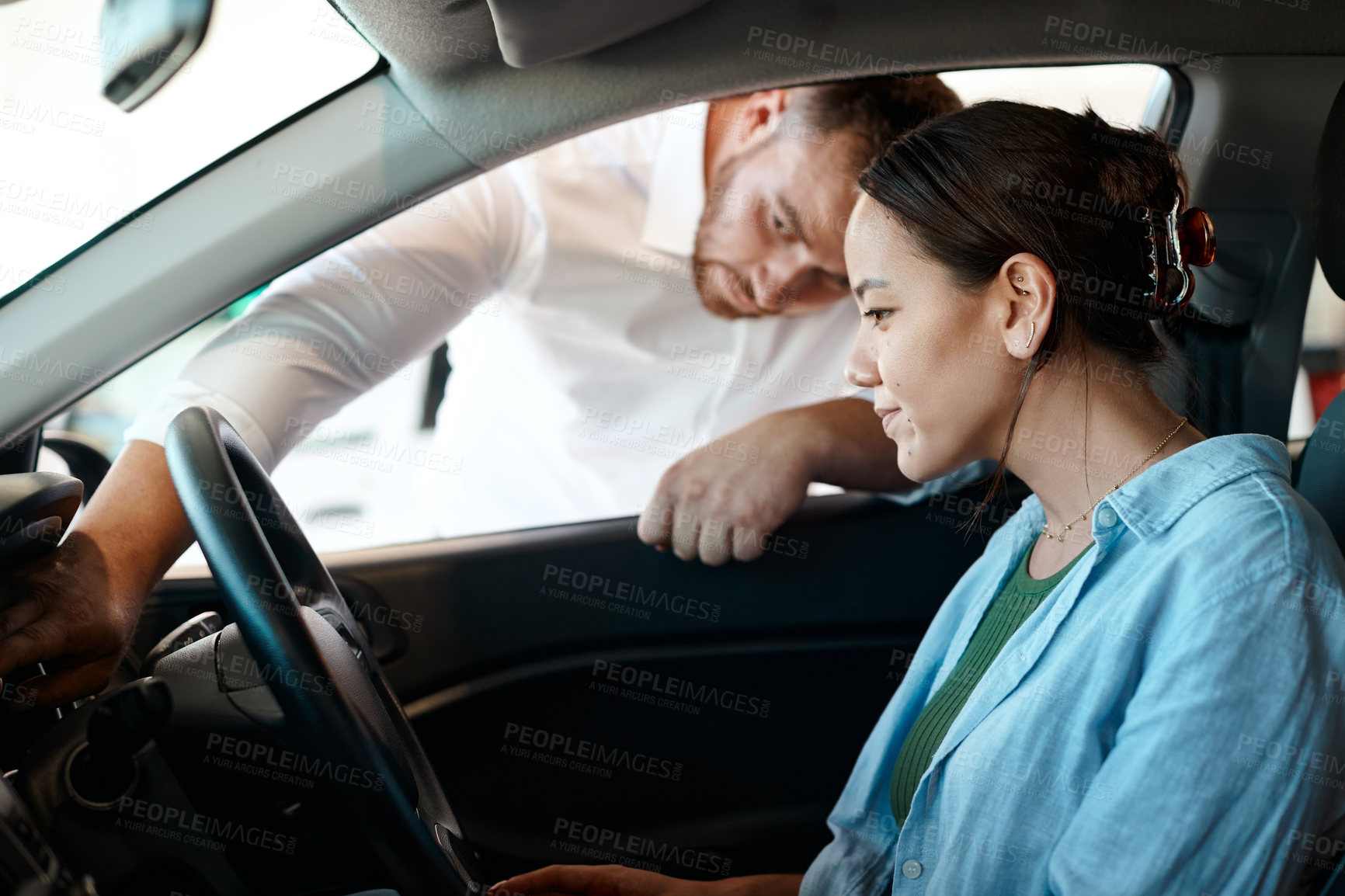 Buy stock photo Shot of a businessman giving a customer a tour of their new car