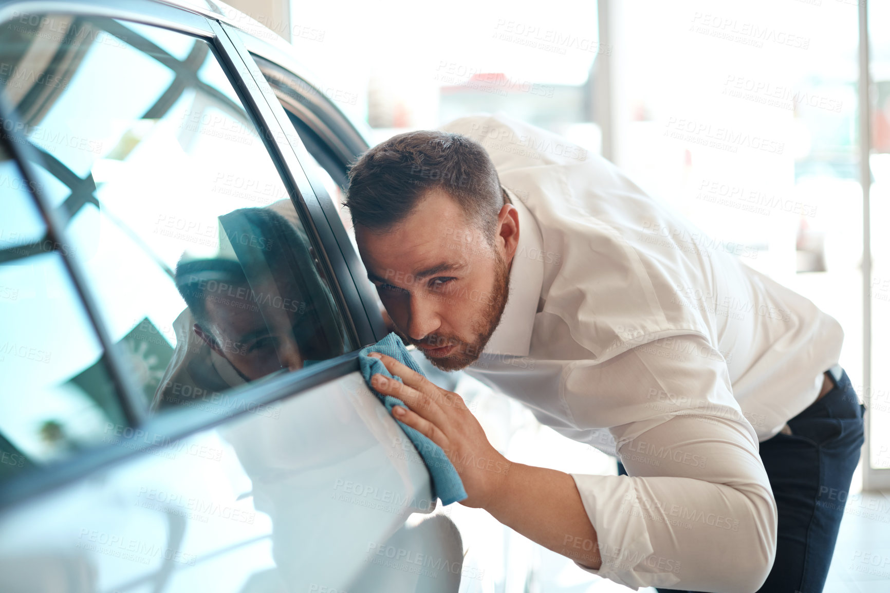 Buy stock photo Dealership, man and cleaning car at showroom for shine at transportation service. Cloth, motor vehicle or wipe body for polishing, maintenance or waxing for protection at carwash with retail salesman