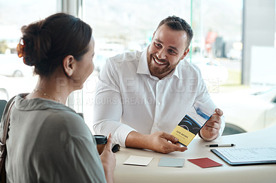 Buy stock photo Shot of a businessman giving his customer a pamphlet to read
