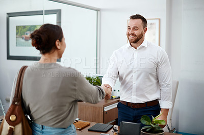 Buy stock photo Shot of a businessman shaking hands with his customer
