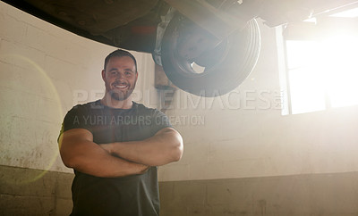 Buy stock photo Portrait, man and arms crossed as car mechanic in workshop with pride for career growth. Garage, confident and smile for startup or small business as engineer with repairs, service and maintenance