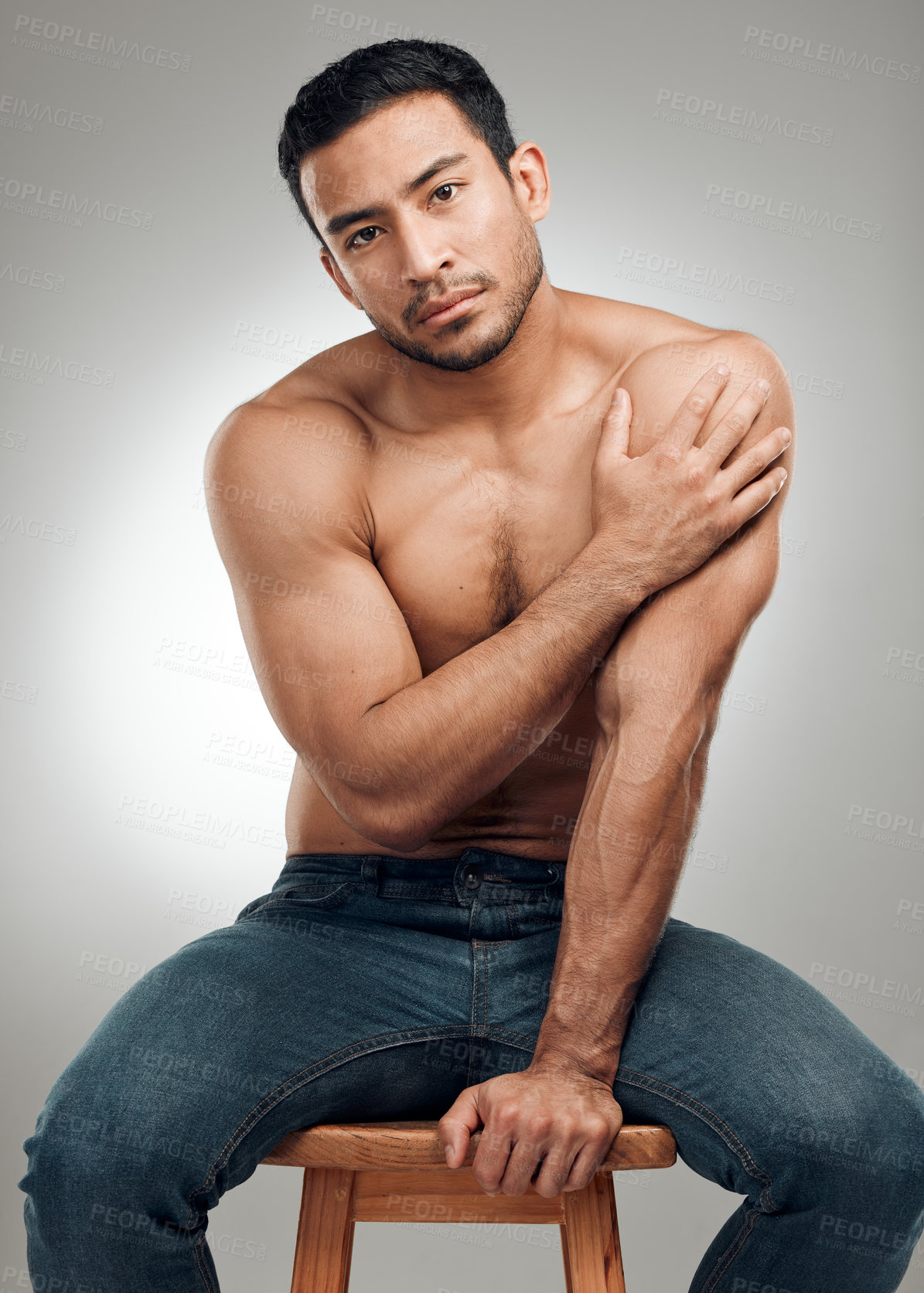 Buy stock photo Man, chair and shirtless in studio portrait, wellness and strong abs muscle on gray background. Male person, denim jeans and topless for fitness, bodybuilder and proud of body or workout results