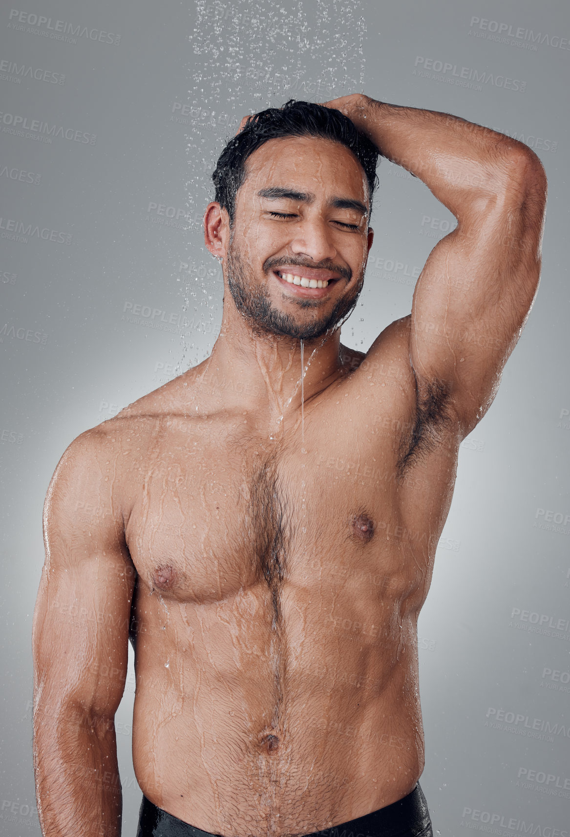 Buy stock photo Man, shower and cleaning in studio for haircare, water and confident for grooming on gray background. Male person, cosmetics and liquid for treatment in morning routine, health and hygiene or beauty