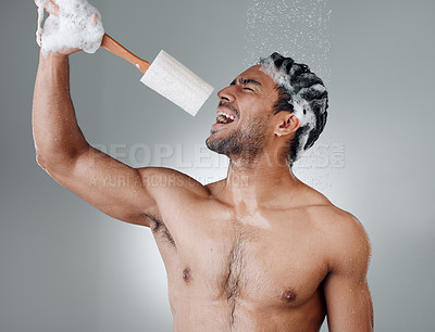 Buy stock photo Shot of a young man singing in the shower against a grey background