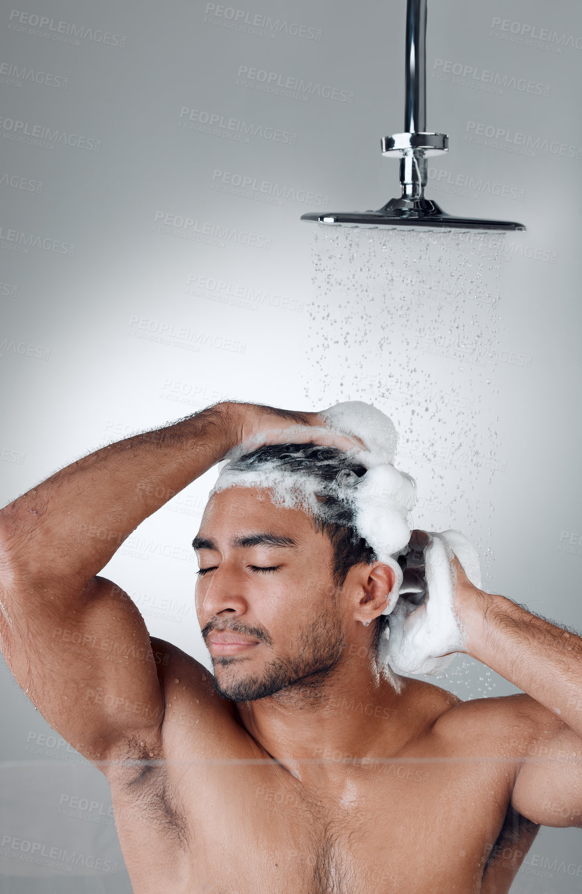 Buy stock photo Man, shower and shampoo in studio for washing hair, water and cleaning or grooming on white background. Male person, cosmetic and foam for treatment in morning routine, haircare and hygiene or beauty