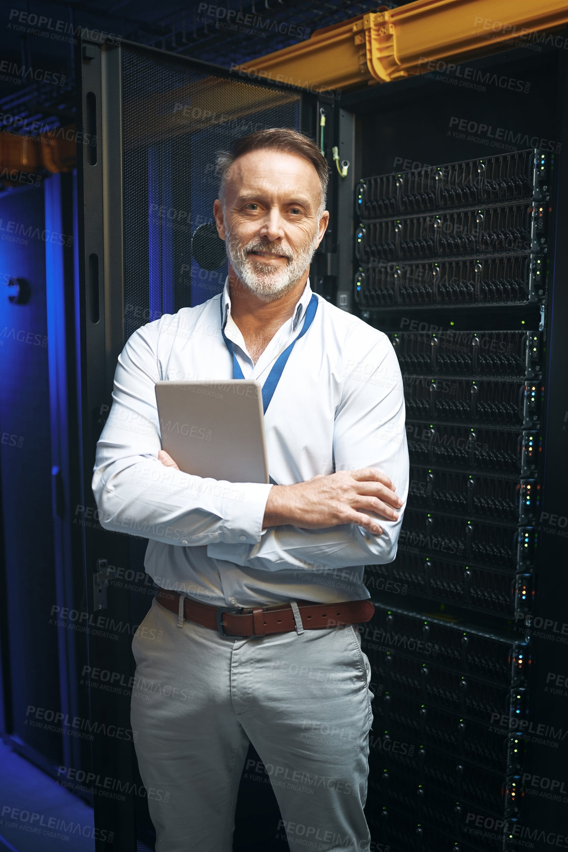 Buy stock photo Portrait of a mature man holding a digital tablet while working in a server room