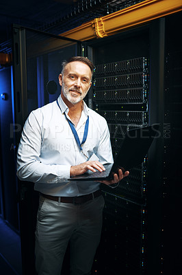 Buy stock photo Portrait of a mature man using a laptop while working in a server room