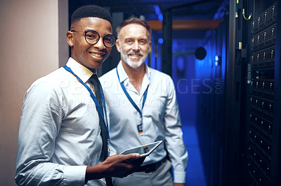 Buy stock photo Portrait of two technicians using a digital tablet while working in a server room