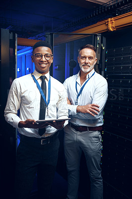 Buy stock photo Portrait of two technicians using a digital tablet while working in a server room