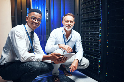 Buy stock photo Portrait of two technicians using a digital tablet while working in a server room