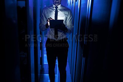 Buy stock photo Closeup shot of an unrecognisable man using a digital tablet while working in a server room