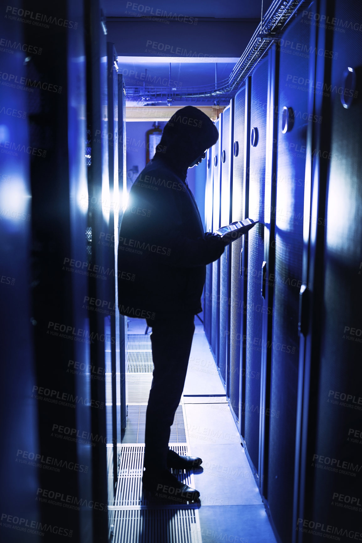 Buy stock photo Shot of a hacker using a digital tablet in a server room