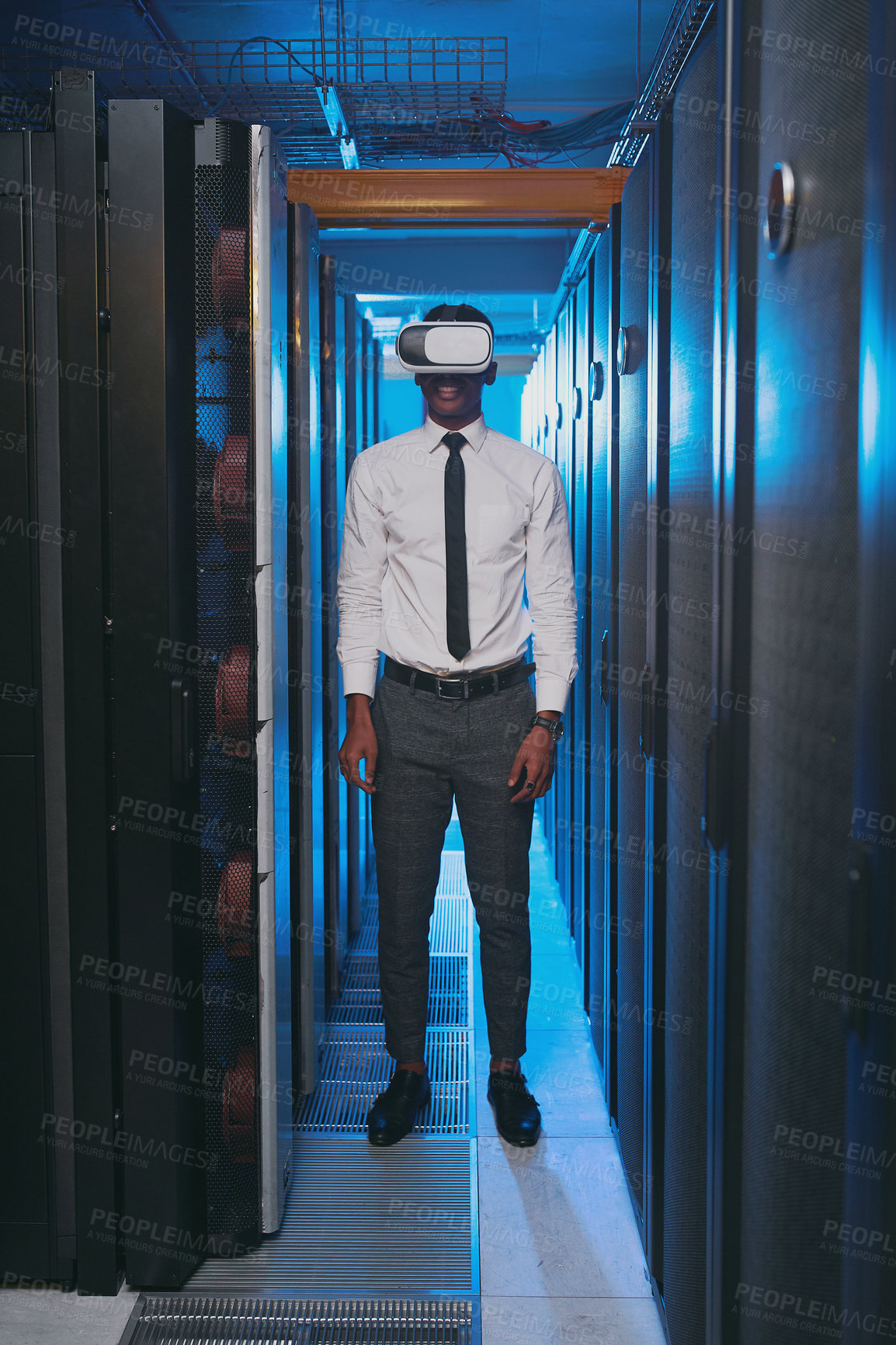 Buy stock photo Full length shot of a young IT specialist standing alone in the server room and wearing a virtual reality headset