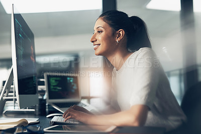 Buy stock photo Shot of a woman using a computer in a modern office