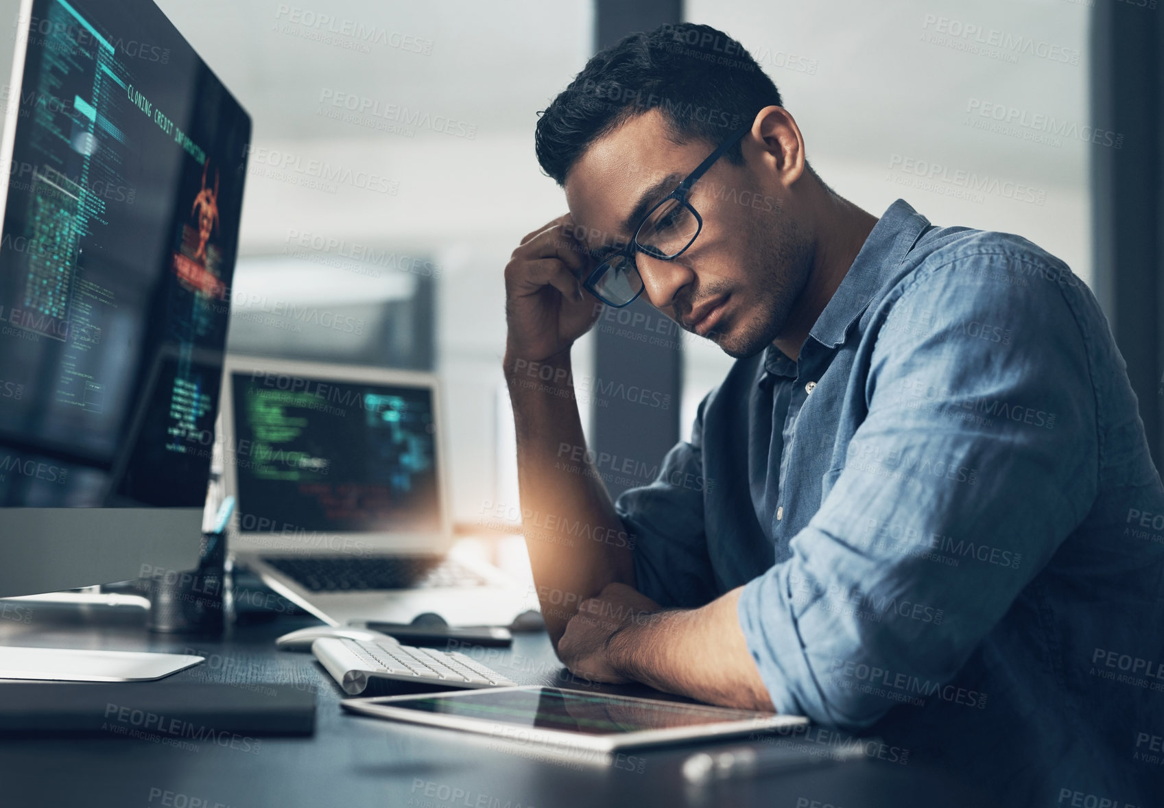 Buy stock photo Shot of an exhausted young man using a headset in a modern office